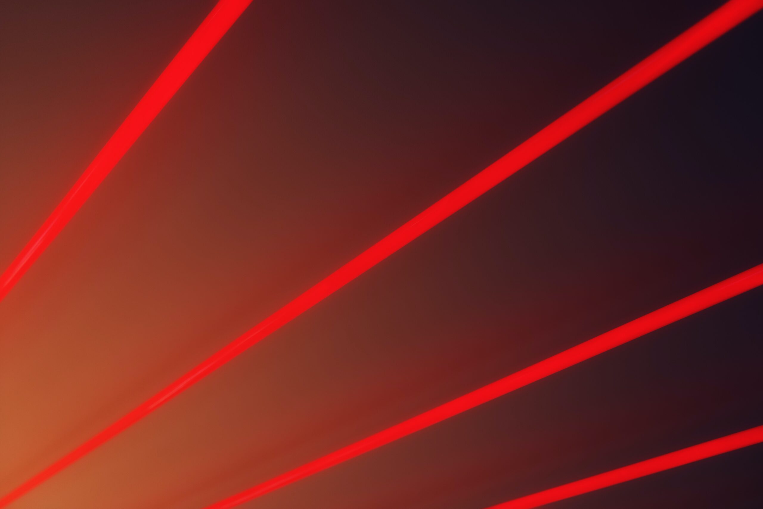 real light sabers Abstract red light trails on a dark gradient background.