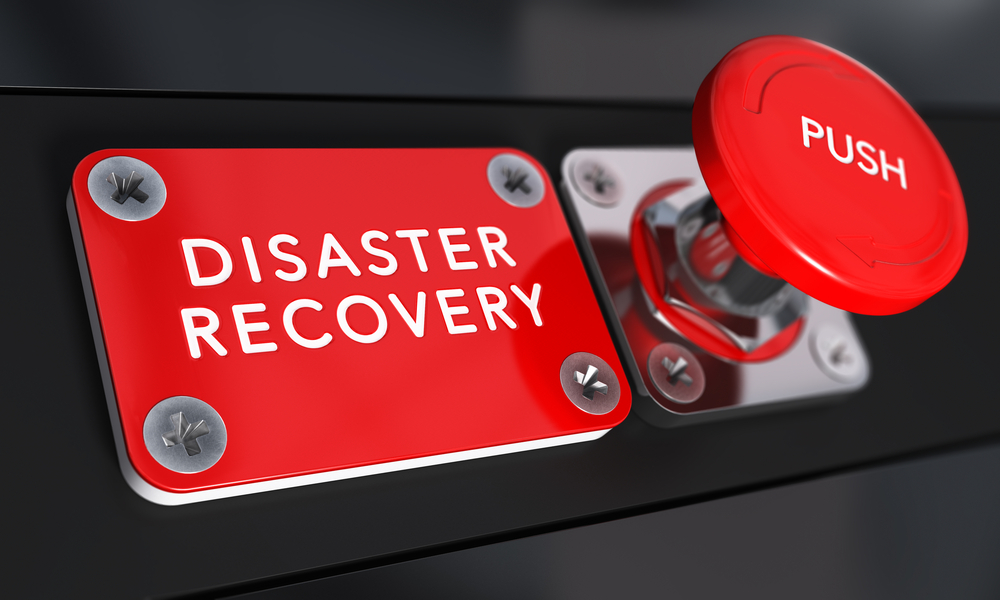 Red disaster recovery button representing emergency data restoration and business continuity.