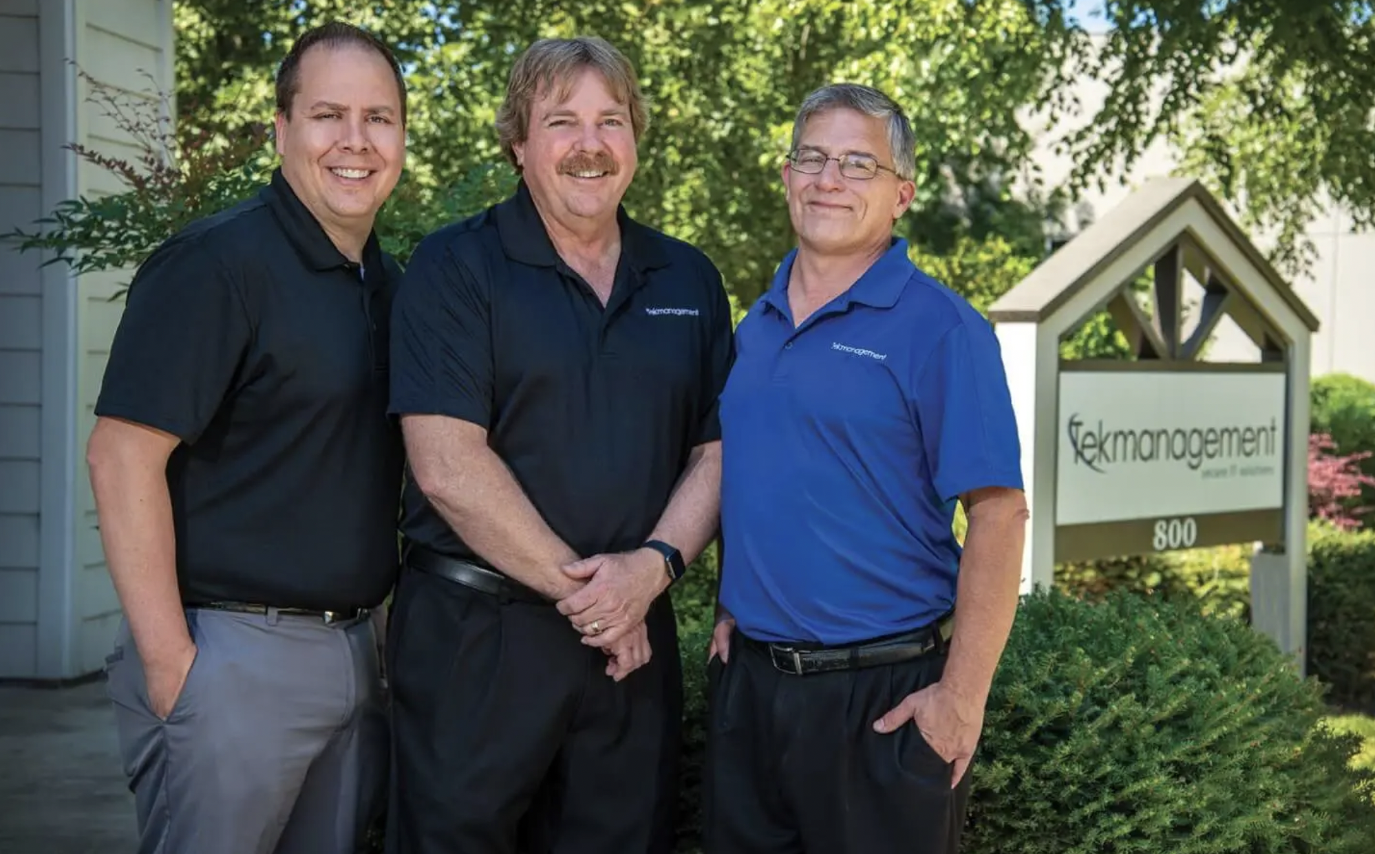 Three TekManagement team members standing outside their office for a SOREDI Edge business feature.