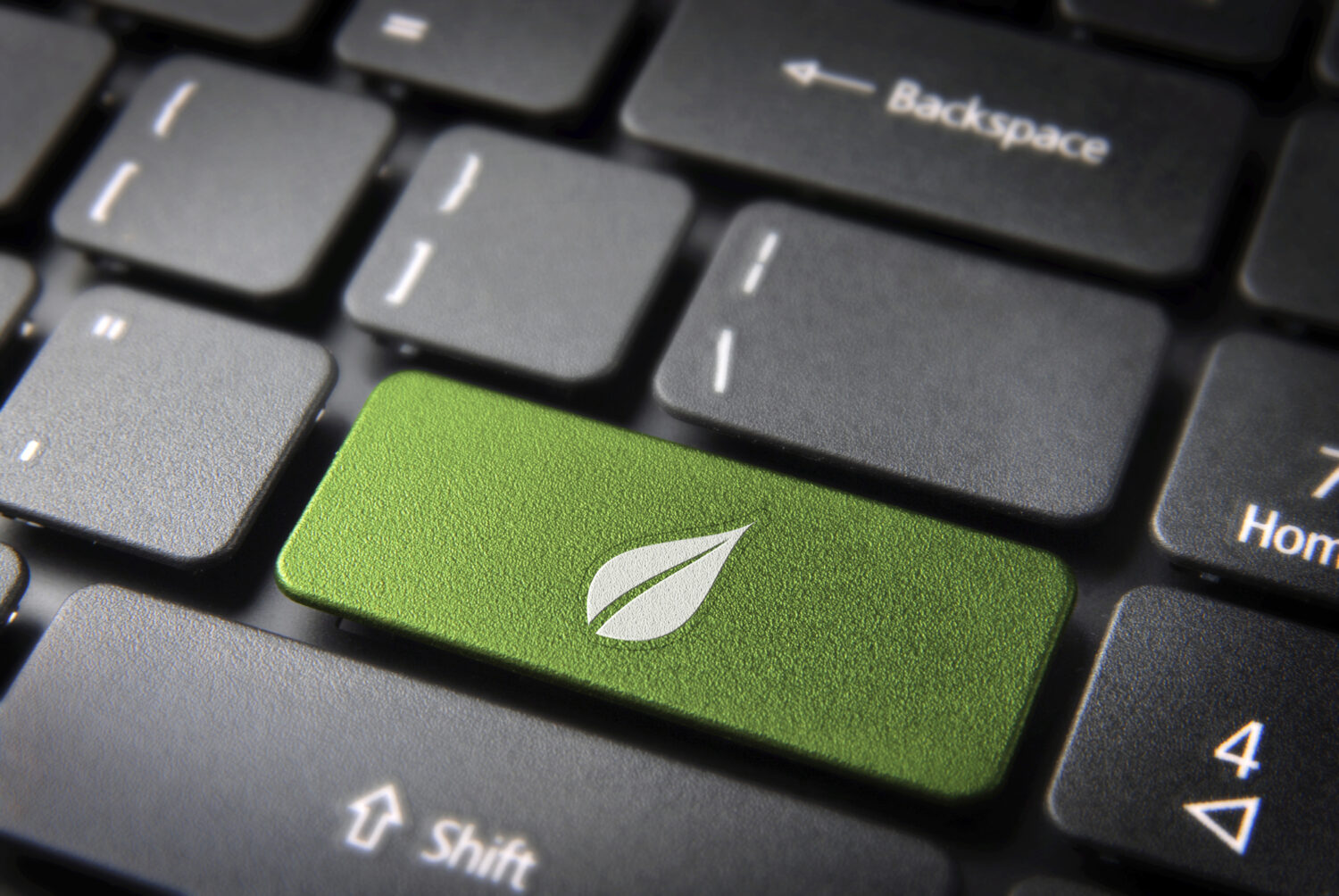 Going Green with Office IT Green keyboard key with a leaf icon, representing eco-friendly office IT practices.