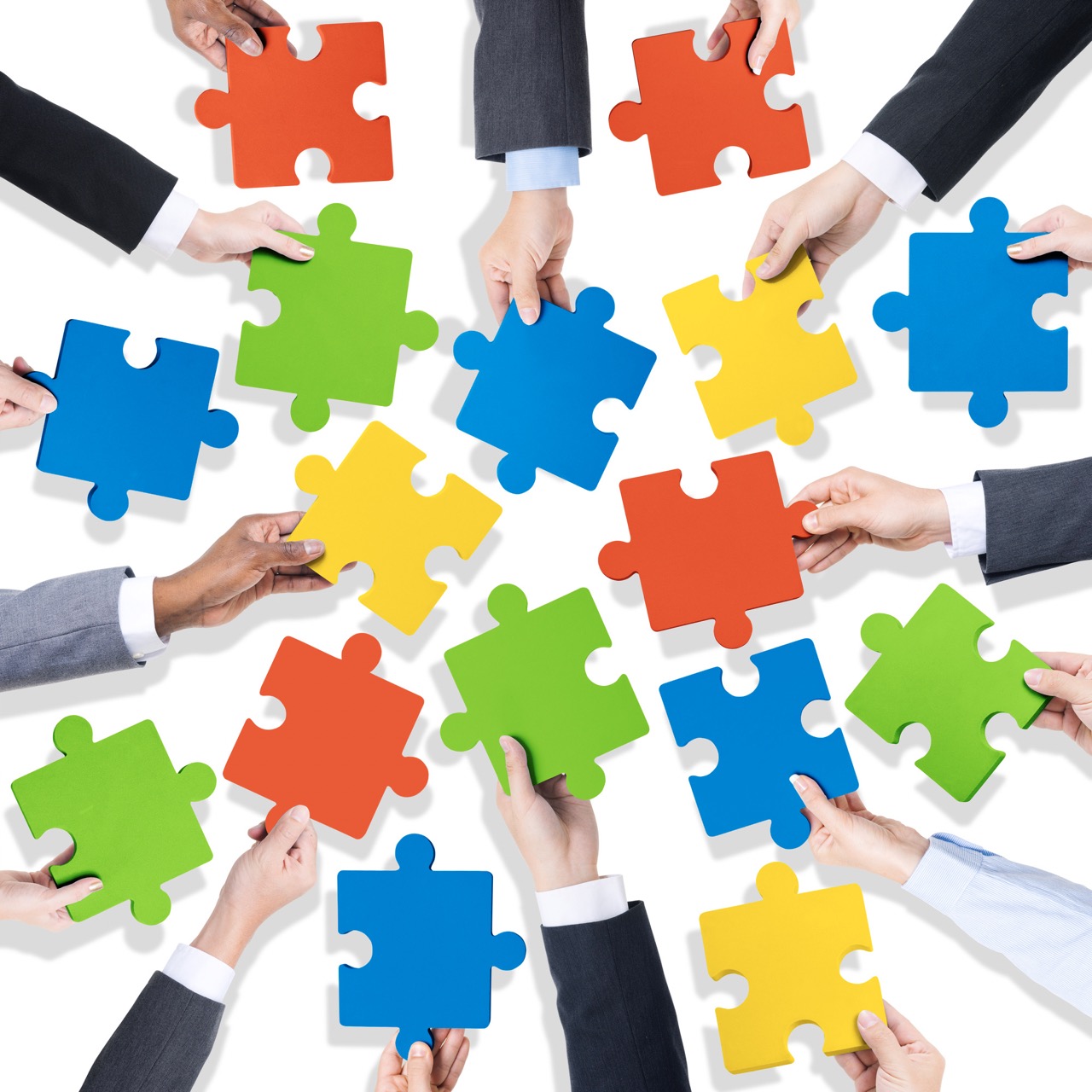 Teamwork and Collaboration Puzzle Pieces Concept Hands holding colorful puzzle pieces, representing teamwork, collaboration, and problem solving.