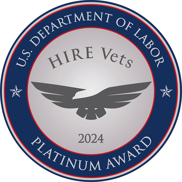 Circular badge with a silver and blue design featuring an eagle graphic and text that reads “U.S. Department of Labor – HIRE Vets Platinum Award 2024.”
