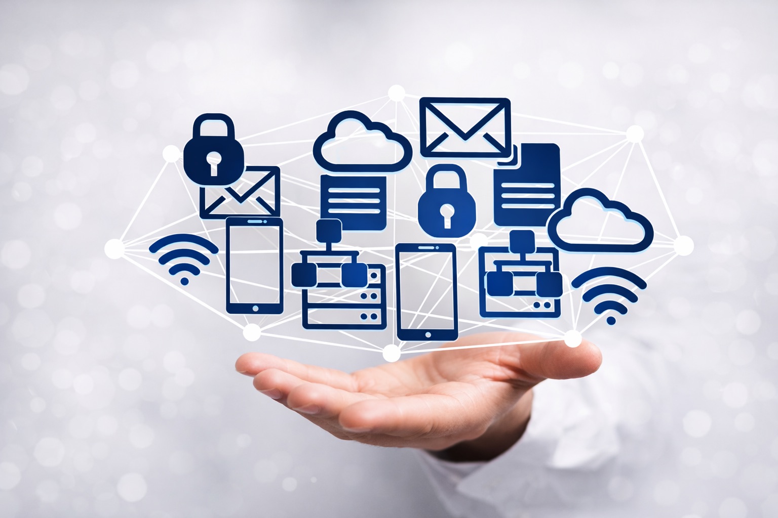 Top Managed IT Services Hand holding a floating network of icons: clouds, locks, email, phones, servers, and Wi-Fi, representing IT services.