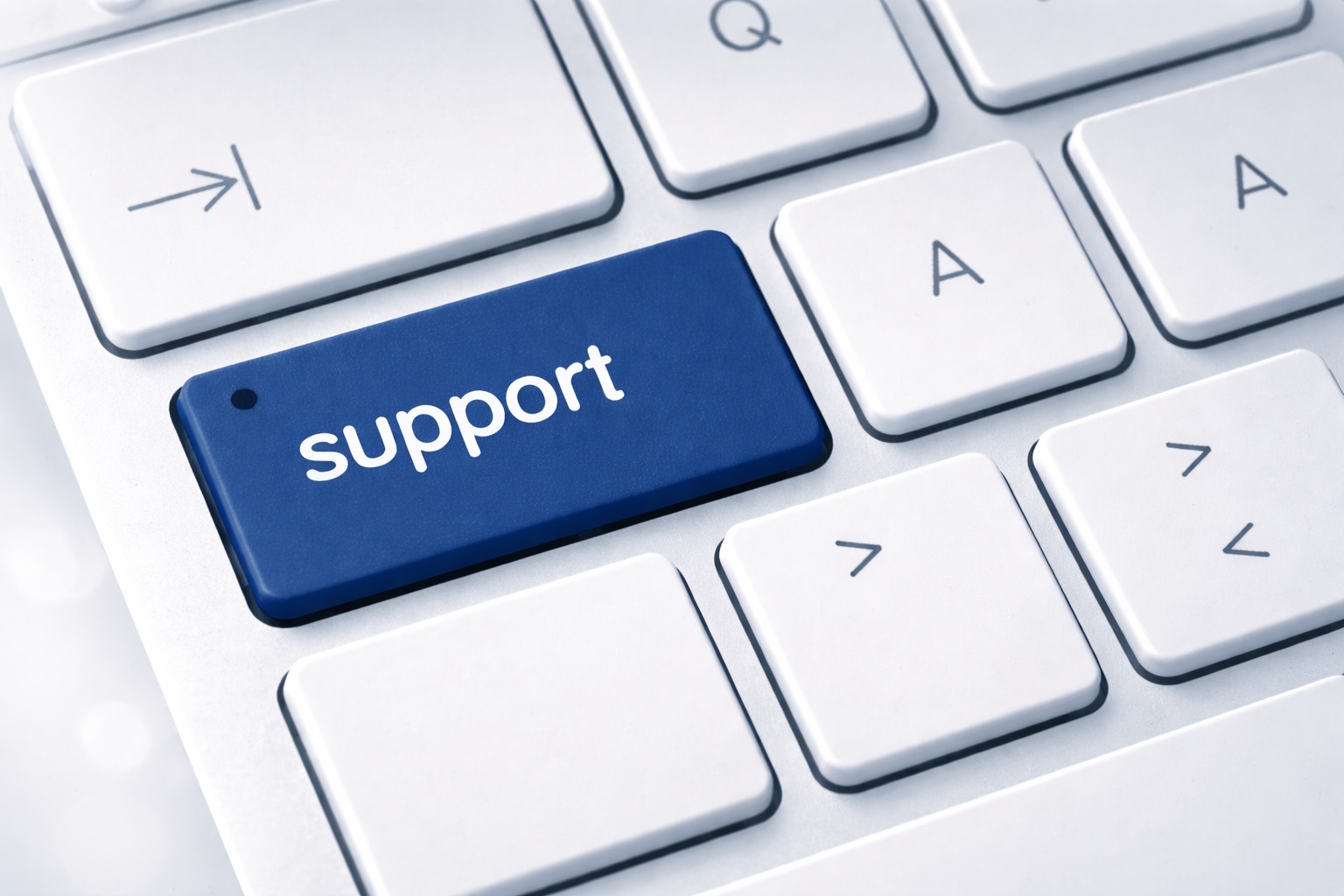 Close-up of a computer keyboard with a blue key labeled “support” in white letters.